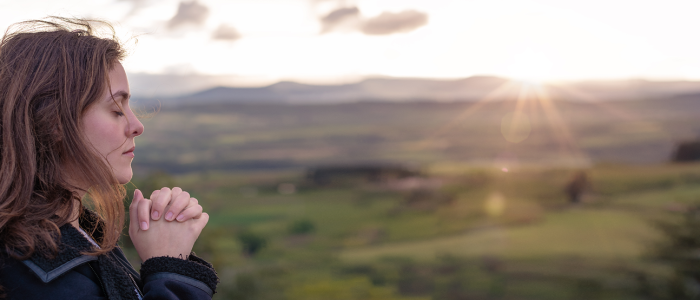 Girl praying in nature