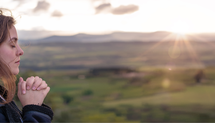 Girl praying in nature